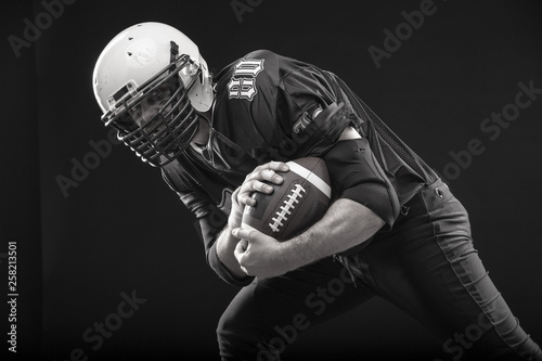 Bearded American football player in helmet, portrait.