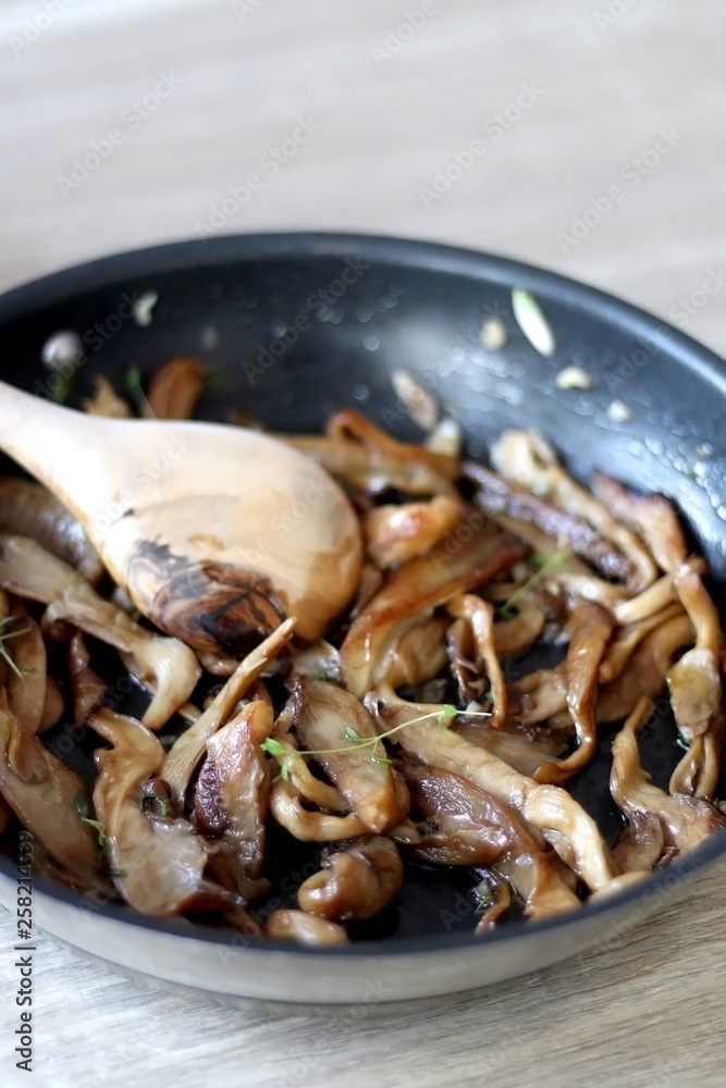 Fried mushrooms with olive oil and herbs. Selective focus.