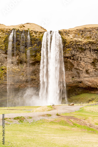 Seljalandsfoss - Seljalandsfoss is located in the South Region in Iceland right by Route 1. One of the interesting things about this waterfall is that visitors can walk behind it into a small cave.