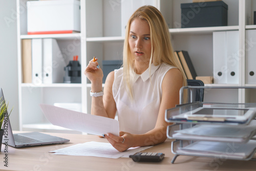 young beautiful woman work at office with documents sit at table study information