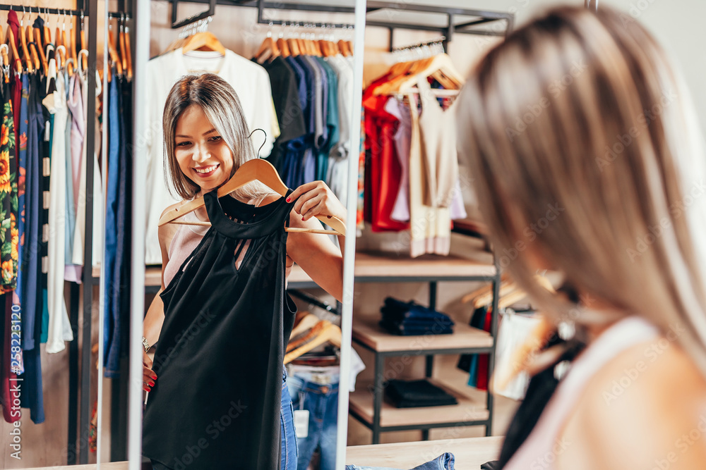 Young woman shopping in clothing store
