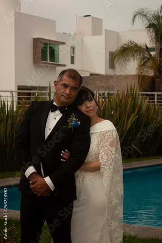 Happy newlyweds smile making their dream come true consummating their love through the Roman Catholic apostolic way according to their religion