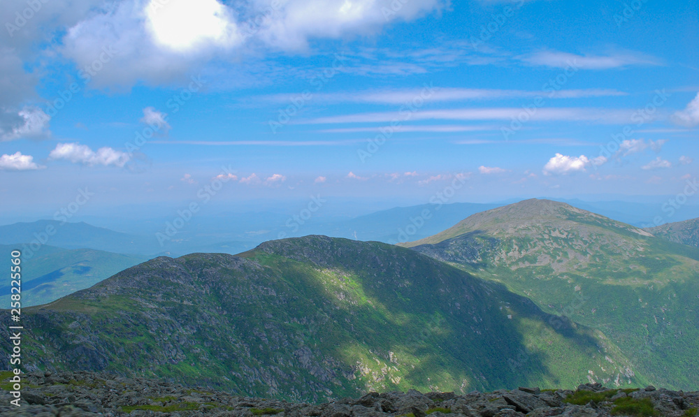 View of Presidential Range of the White Mountains from the top of Mount Washington New Hampshire with cloud shadows 