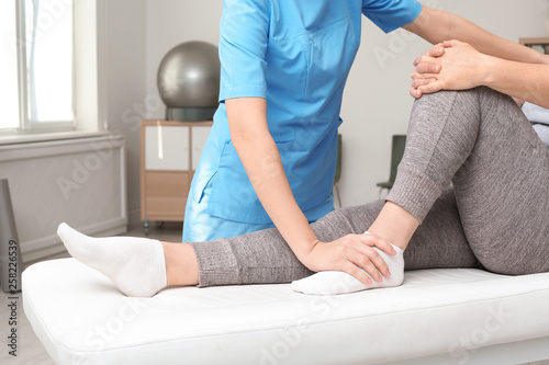Physiotherapist working with patient in clinic, closeup. Rehabilitation therapy