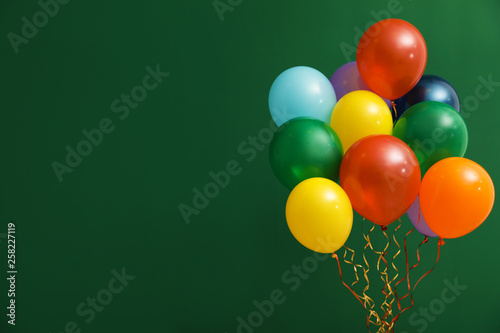 Photography Bunch of bright balloons on color background, space for text