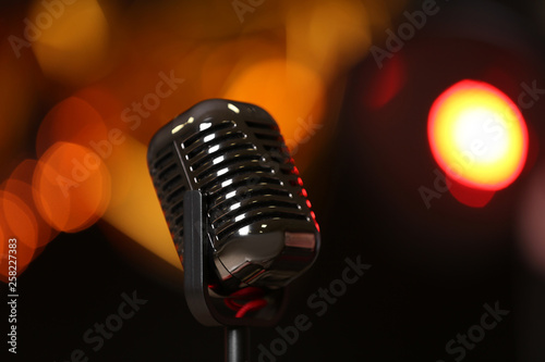 Photography Retro microphone against festive lights. Musical equipment