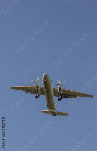 Airplane flying against the sky, bottom view