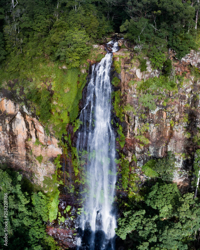 Beautiful aerial view of a waterfall at sunrise in the middle of a rainforest. Beautiful hike, walk, adventure location in Australia, Queensland, Twin Falls circuit © FRPhotos
