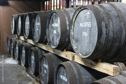 Wooden barrels with whiskey or wine or sake