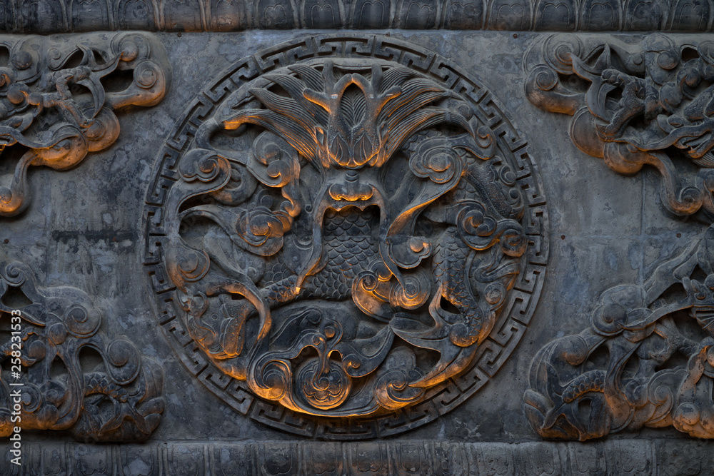 Carving of a Chinese dragon in an octagon on a temple wall in Xi'An, Shaanxi, China