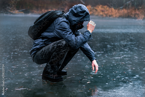 Man on ice in the rain.