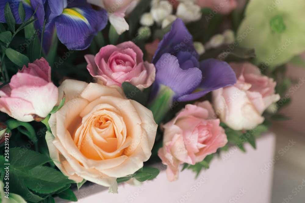 Obraz premium Florist at work: pretty young blond woman making fashion modern bouquet of different flowers