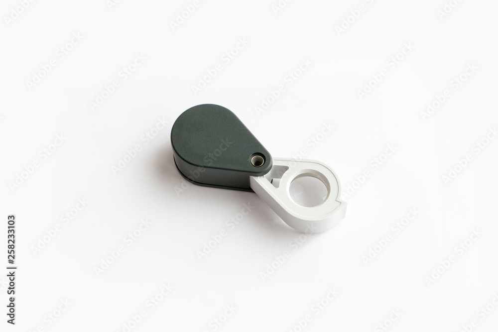 Magnifying glass for diamonds or see the amulet Isolated on a White Background. Magnifying glass for diamonds or see the amulet Isolated on a White Background.
