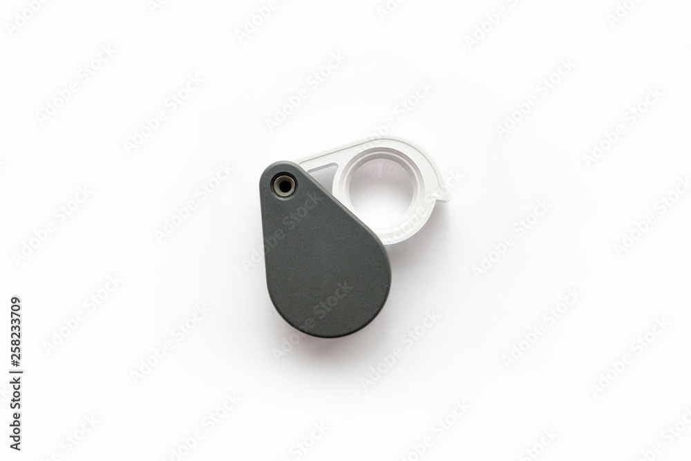 Magnifying glass for diamonds or see the amulet Isolated on a White Background. Magnifying glass for diamonds or see the amulet Isolated on a White Background.