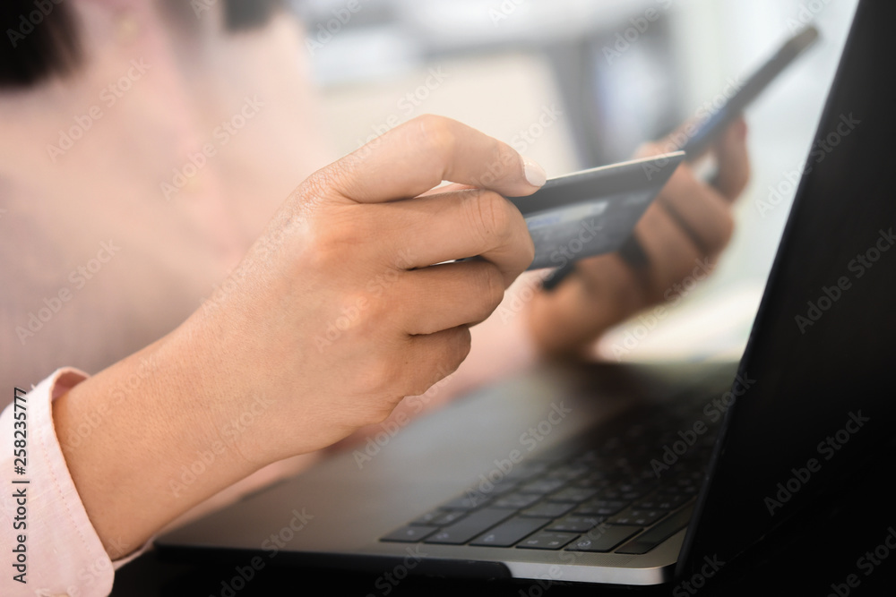 Fototapeta premium Online payment,woman using credit card for online shopping. Cyber Monday Concept