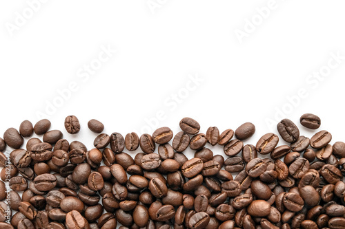Roasted coffee beans isolated on white background. Close-up.