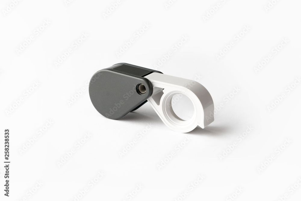 Magnifying glass for diamonds or see the amulet Isolated on a White Background. Magnifying glass for diamonds or see the amulet Isolated on a White Background.