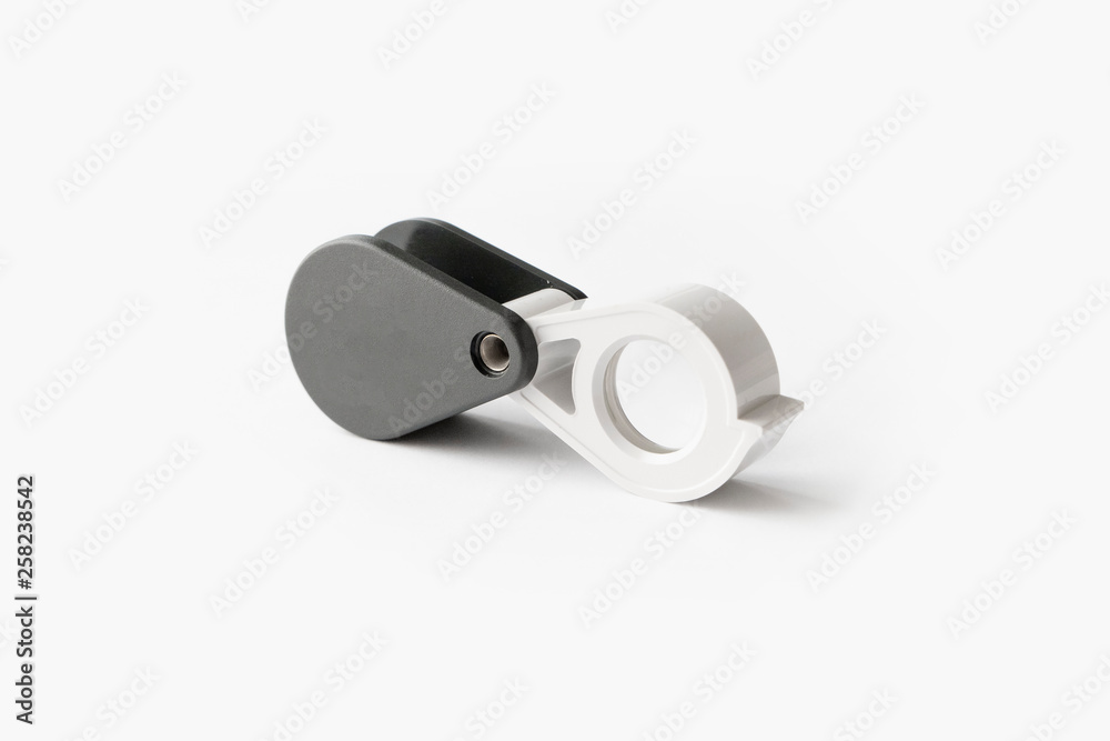 Magnifying glass for diamonds or see the amulet Isolated on a White Background. Magnifying glass for diamonds or see the amulet Isolated on a White Background.
