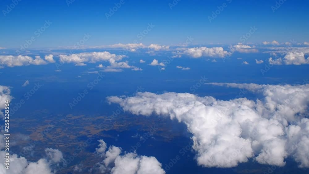 Above the clouds, flying in the air. View of clouds through airplane window. Above the clouds, flying in the air. View of clouds through airplane window.
