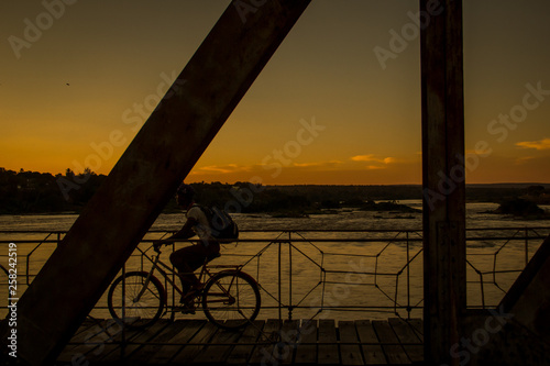 Sunset on the bridge connecting Pirapora and Buritizeiro, in Minas Gerais, on the São Francisco river. Every day thousands of people cross the bridge by bike, on foot or by motorbike.