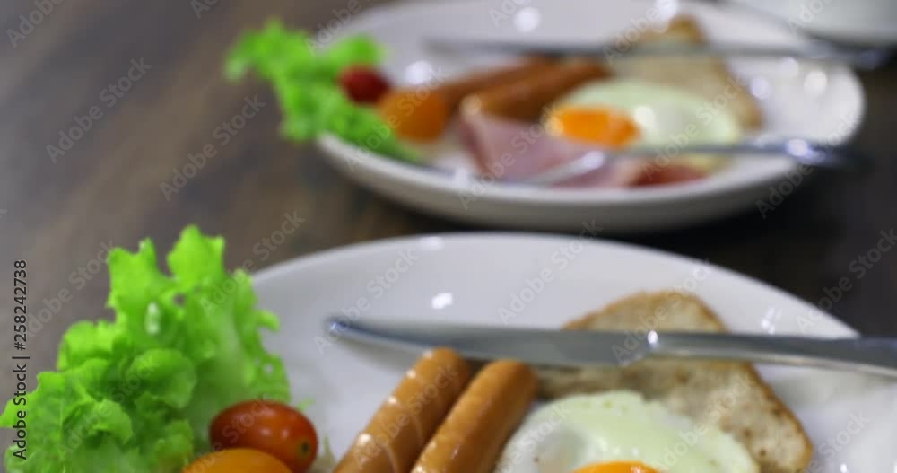 Panning scene video of plates of breakfast, ham, fried egg, sausage, it blurred and turn to clear at the end. Panning scene video of plates of breakfast, ham, fried egg, sausage, it blurred and turn to clear at the end.