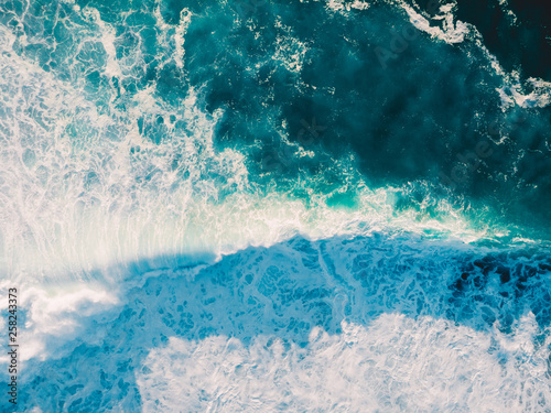 Aerial view of big wave with foam. Blue ocean waves
