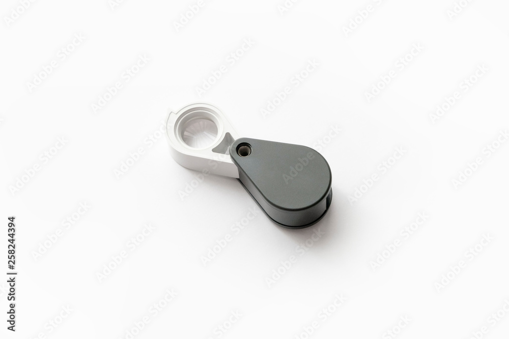 Magnifying glass for diamonds or see the amulet Isolated on a White Background. Magnifying glass for diamonds or see the amulet Isolated on a White Background.