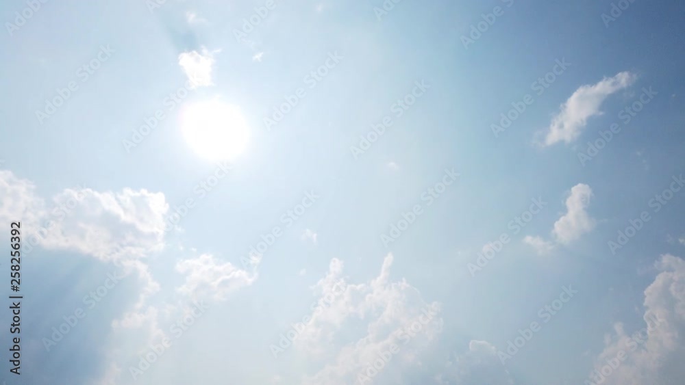 4k Video Time Lapse WS low angle view white clouds moving in blue sky under the sun with sunlight shining in day time 4k Video Time Lapse WS low angle view white clouds moving in blue sky under the sun with sunlight shining in day time