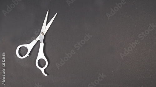 Barber scissors isolated on black background.