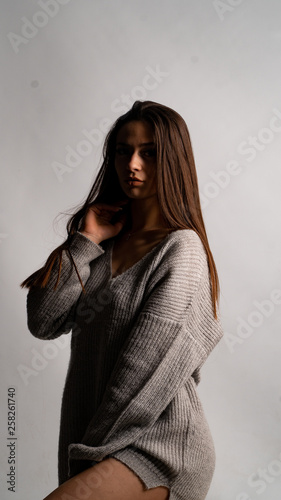 beautiful sexy girl, posing gray dress, white background