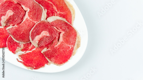 raw beef on a plate .