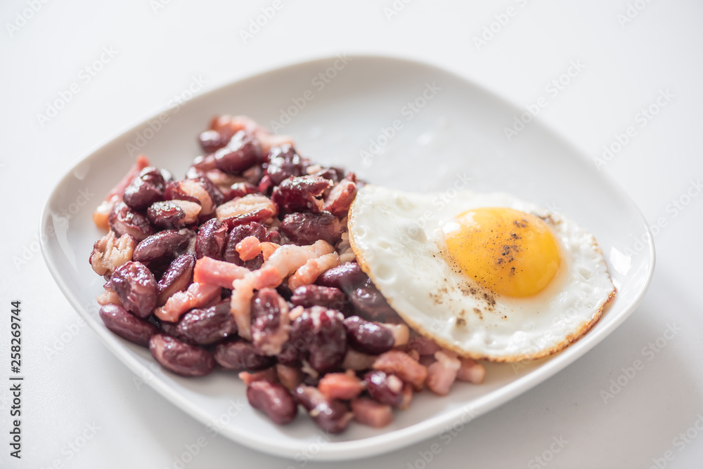 English tastefull breakfast with fried bacon, beans and eggs English tastefull breakfast with fried bacon, beans and eggs