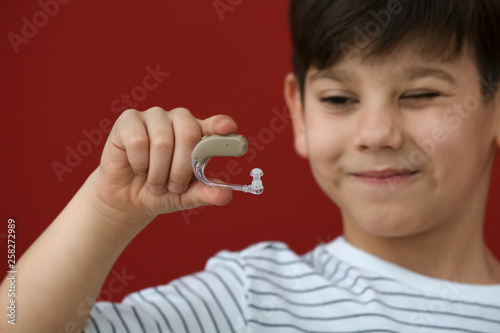 Little boy with hearing aid...
