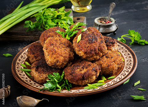 Schilderij op canvas Juicy delicious meat cutlets on a dark table. Russian cuisine.