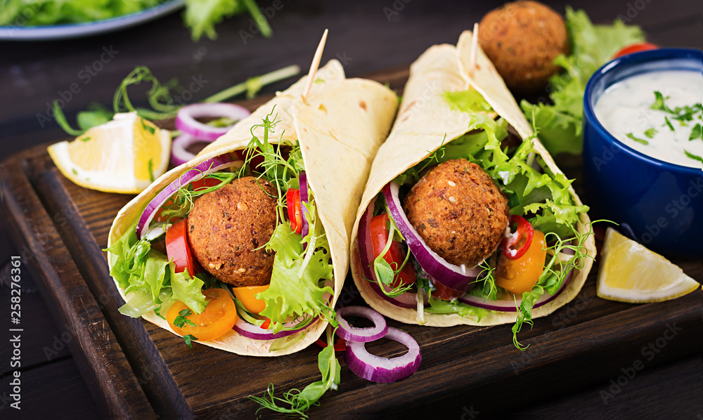 Tortilla wrap with falafel and fresh salad. Vegan tacos. Vegetarian healthy food. Tortilla wrap with falafel and fresh salad. Vegan tacos. Vegetarian healthy food.
