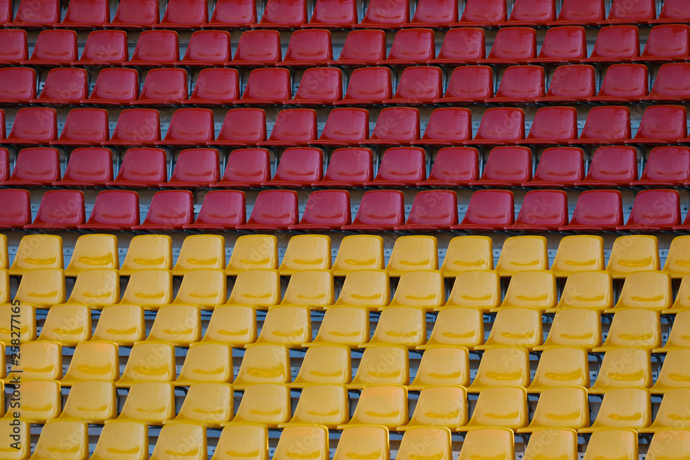Fototapeta premium Empty seats in the stadium, red and yellow seats