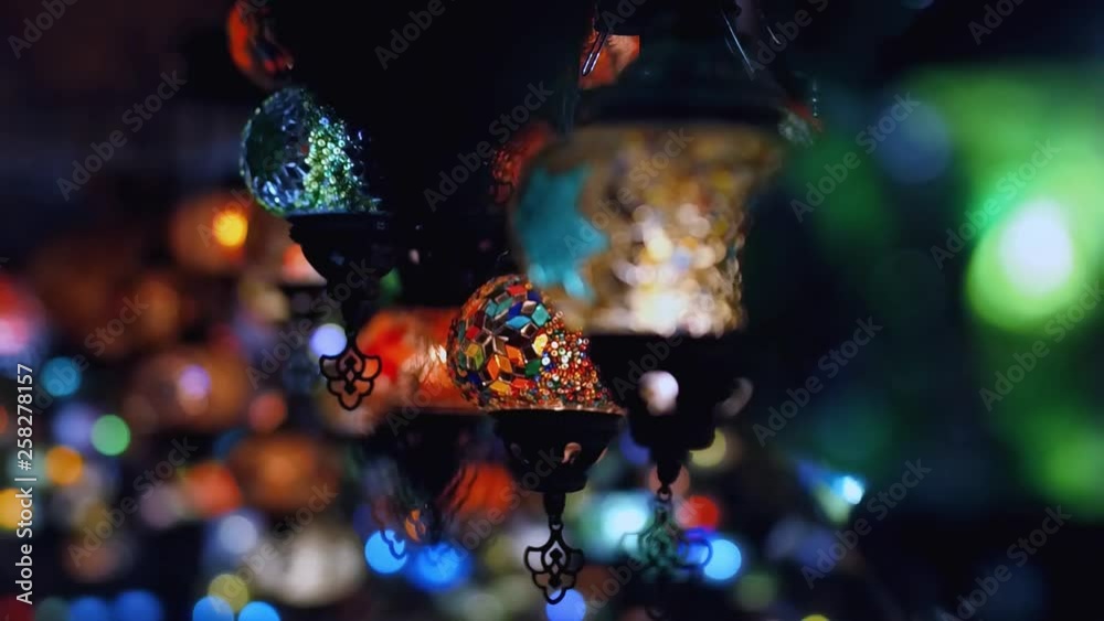 Slowmotion. Camera moving from left to right throught traditional turkish lamps at night time Slowmotion. Camera moving from left to right throught traditional turkish lamps at night time
