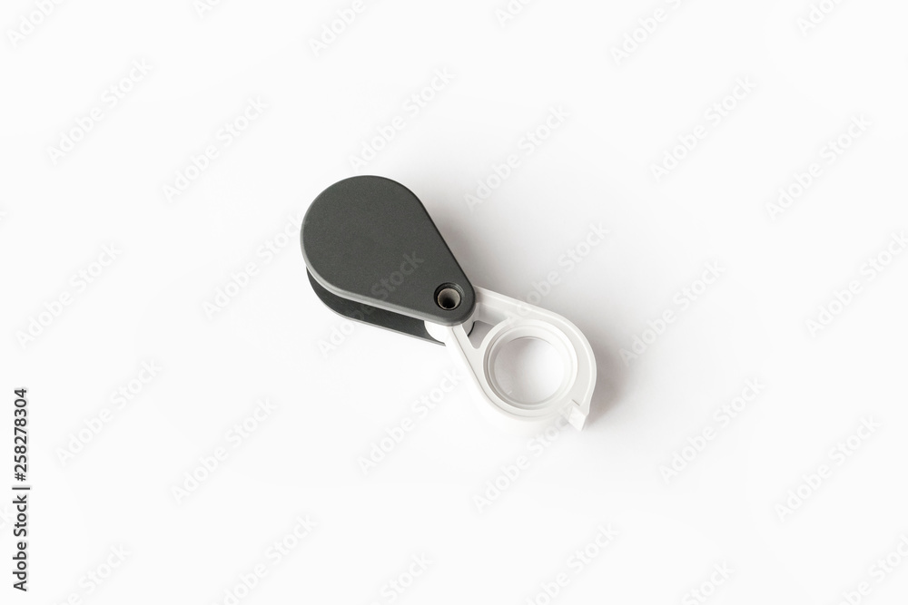 Magnifying glass for diamonds or see the amulet Isolated on a White Background. Magnifying glass for diamonds or see the amulet Isolated on a White Background.