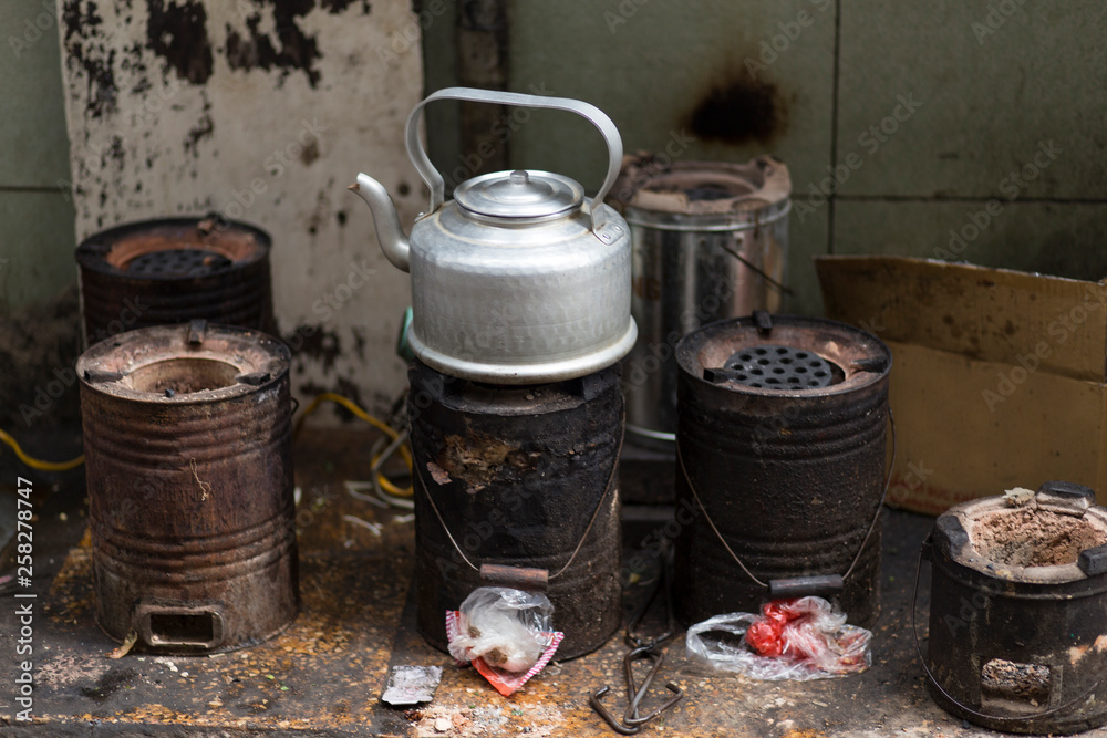 Teapot boiling on rustic stoves in the streets of Hanoi, Vietnam Teapot boiling on rustic stoves in the streets of Hanoi, Vietnam