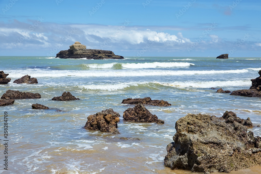 Sharp stones protruding from the water at low tide. Atlantic ocean coast Sharp stones protruding from the water at low tide. Atlantic ocean coast