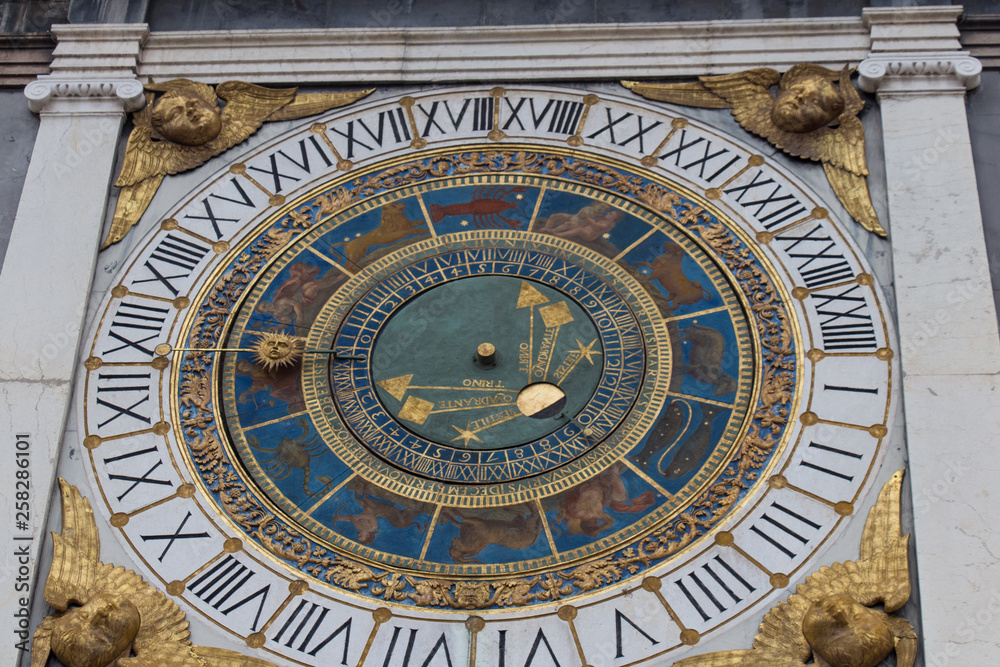Clock tower with historical astronomical clock at Piazza Loggia, Brescia, Lombardy, Italy.