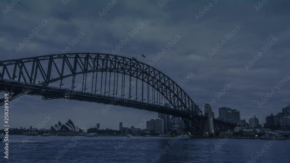 Nightfall in Sydney, Australia. Most iconic buildings of Sydney Opera House and Sydney Harbour Bridge in the view with the illuminated cityscape of city centre in the background. Nightfall in Sydney, Australia. Most iconic buildings of Sydney Opera House and Sydney Harbour Bridge in the view with the illuminated cityscape of city centre in the background.