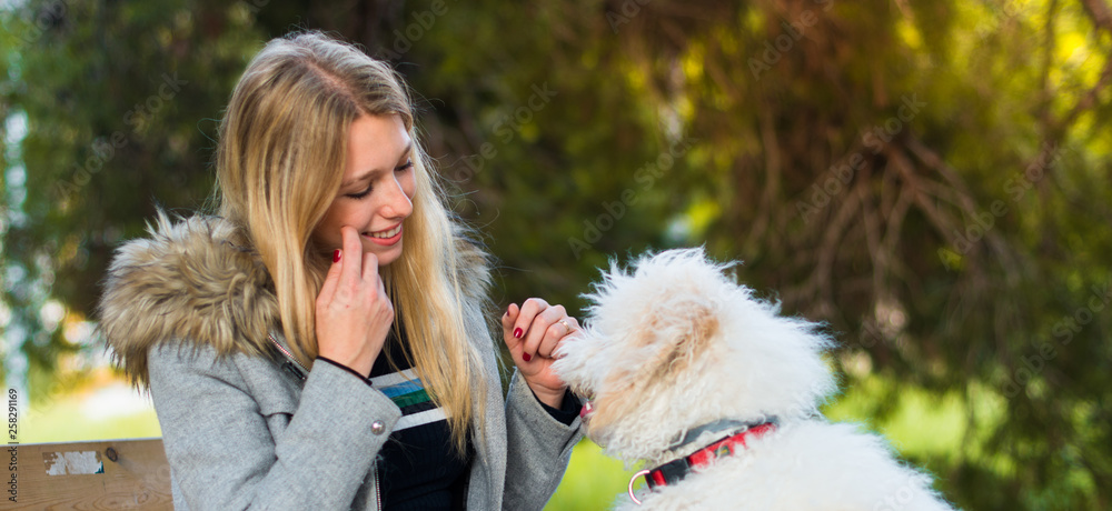 Young girl with her dog in a park Young girl with her dog in a park