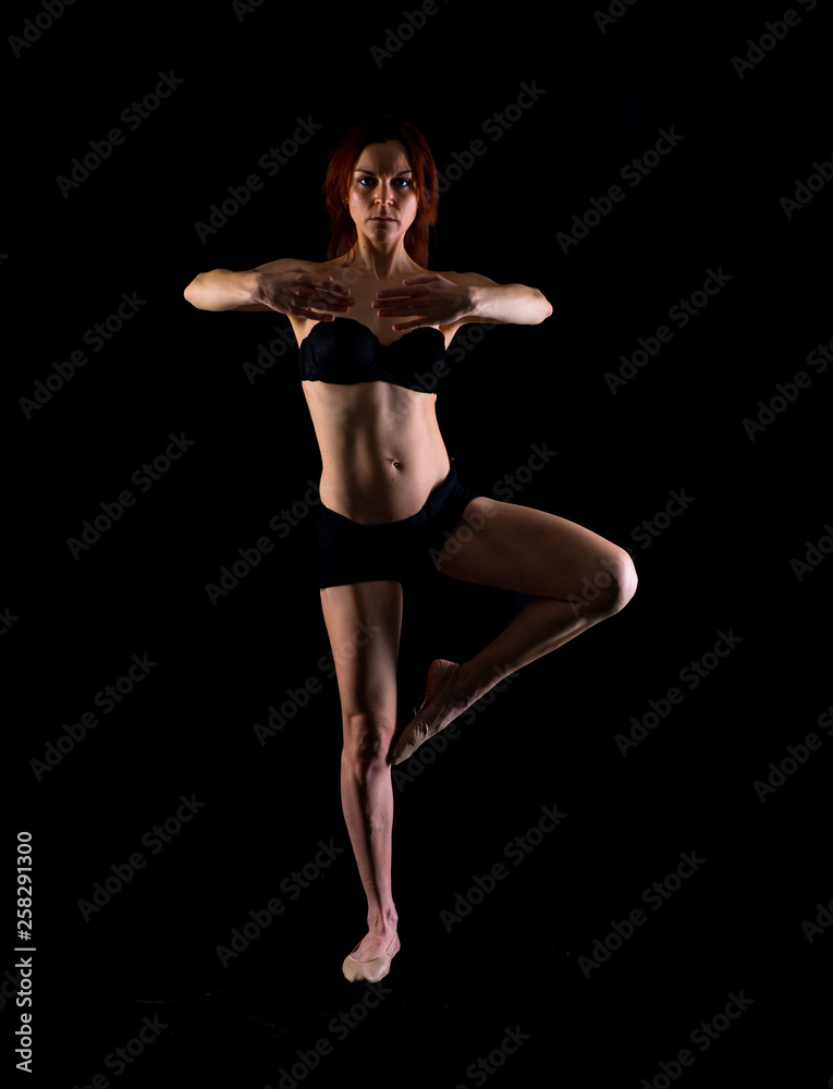 Redhead Girl doing ballet in studio