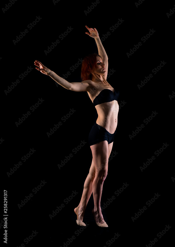 Redhead Girl doing ballet in studio