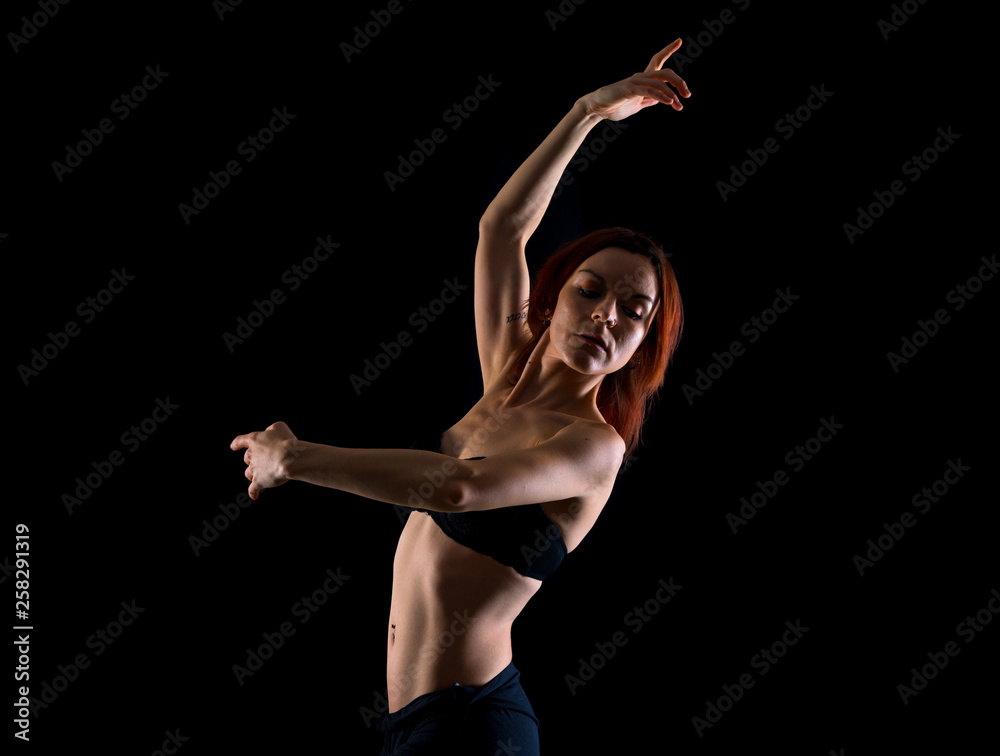 Redhead Girl doing ballet in studio