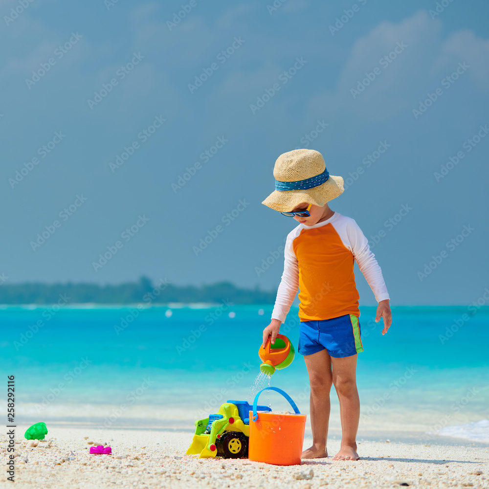 Three year old toddler playing on beach Three year old toddler playing on beach