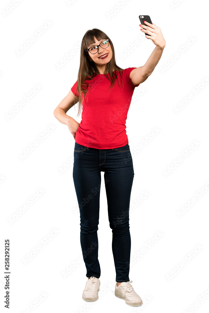 Full-length shot of Woman with glasses making a selfie Full-length shot of Woman with glasses making a selfie