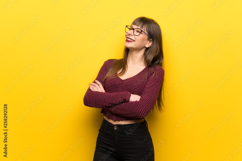Woman with glasses over yellow wall Happy and smiling Woman with glasses over yellow wall Happy and smiling