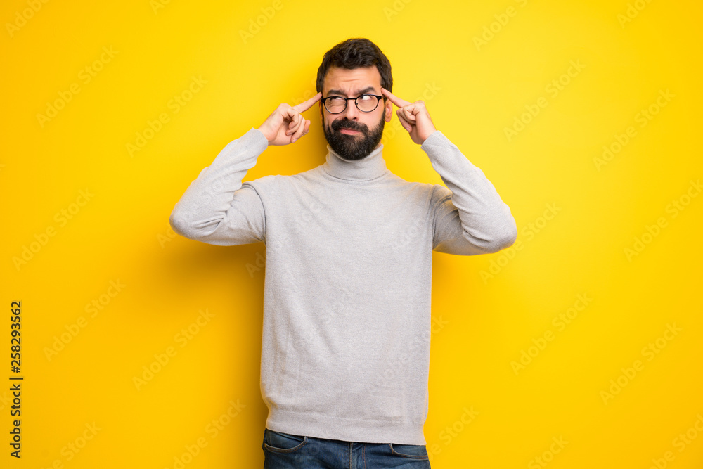 Man with beard and turtleneck having doubts and thinking Man with beard and turtleneck having doubts and thinking